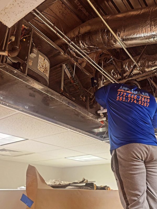 Apex Cool Air technician repairing Air conditioner